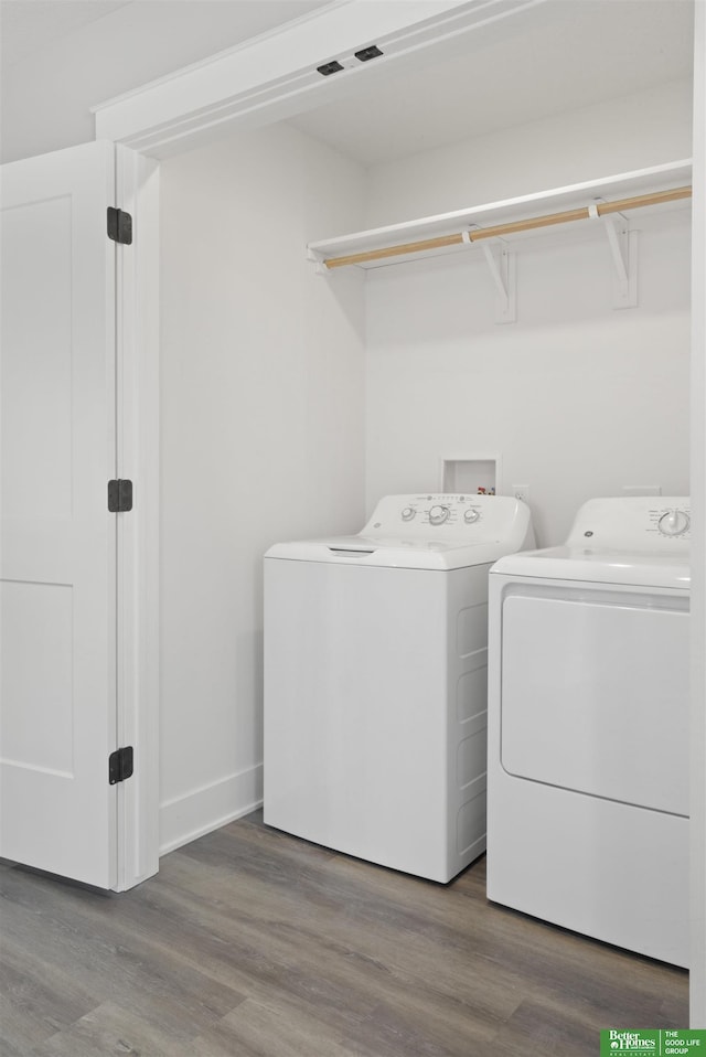 laundry room featuring hardwood / wood-style flooring and washing machine and clothes dryer