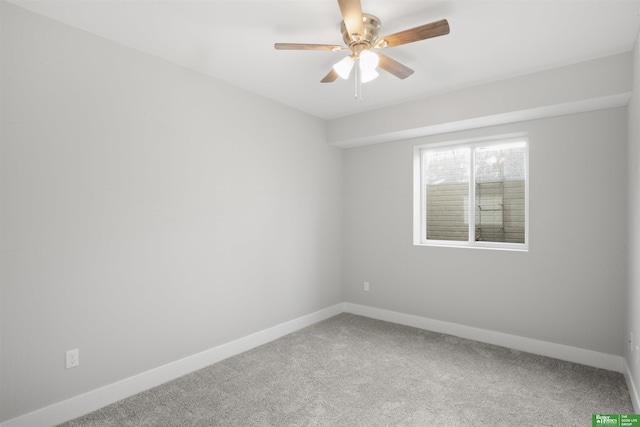 spare room featuring ceiling fan and carpet