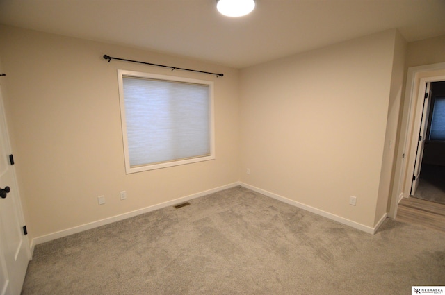 unfurnished bedroom featuring light carpet