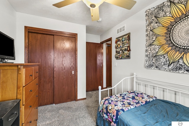 bedroom featuring ceiling fan, a closet, and carpet floors