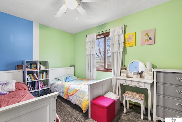 bedroom with a textured ceiling, carpet floors, and ceiling fan