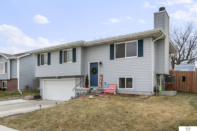 bi-level home with a front yard and a garage