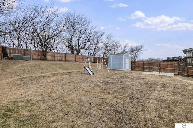 view of yard featuring a storage shed and a playground