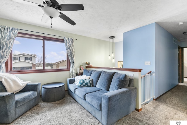 living room with a textured ceiling, carpet floors, and ceiling fan