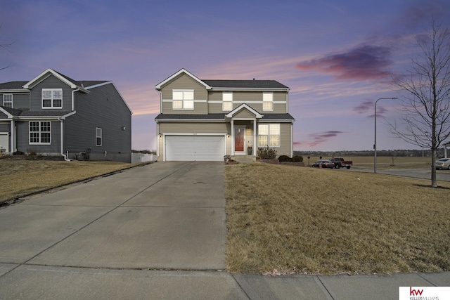 front of property featuring a garage and a lawn