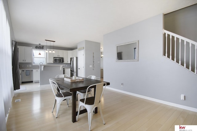 dining space featuring light hardwood / wood-style flooring