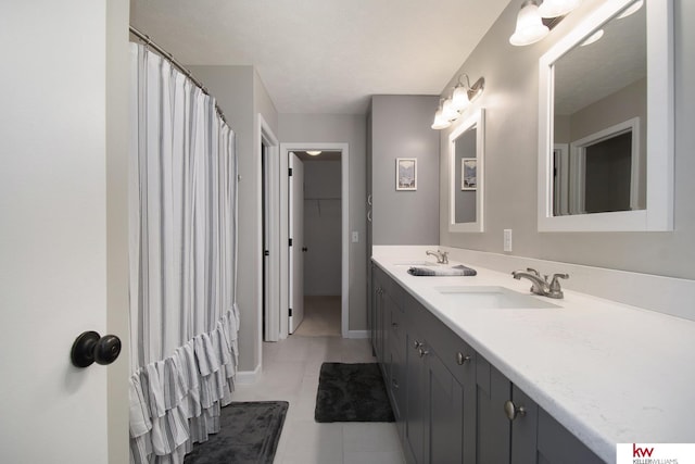 bathroom with tile patterned floors and vanity