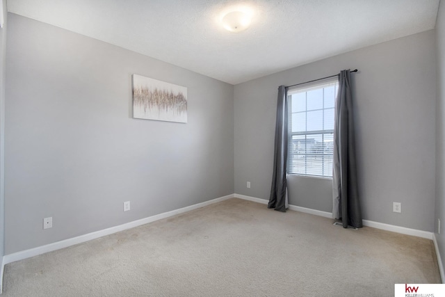 unfurnished room featuring light carpet