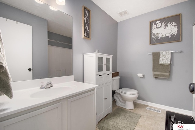 bathroom with vanity, toilet, and a shower