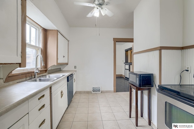 kitchen with ceiling fan, white cabinetry, light tile patterned floors, sink, and stainless steel appliances