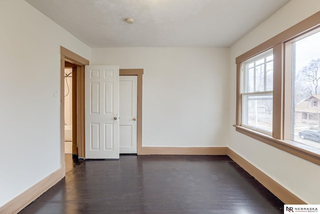 spare room with dark wood-type flooring