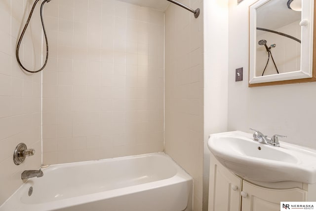 bathroom featuring vanity and tiled shower / bath