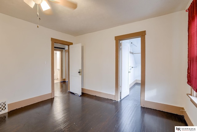 empty room featuring ceiling fan and dark hardwood / wood-style floors