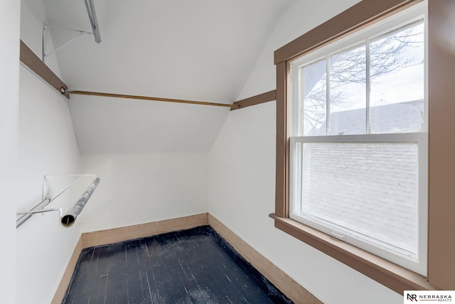 spacious closet featuring dark wood-type flooring and lofted ceiling