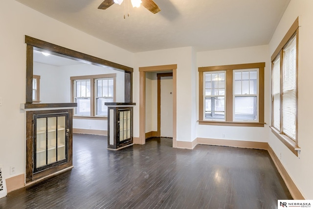 spare room with dark hardwood / wood-style floors and ceiling fan