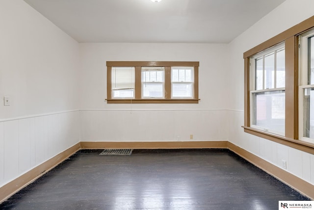 unfurnished room with dark wood-type flooring