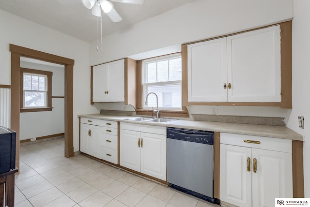 kitchen with white cabinetry, light tile patterned floors, stainless steel dishwasher, sink, and ceiling fan