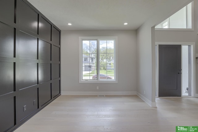 foyer entrance with light wood-type flooring