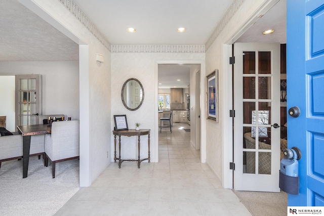 entryway featuring light carpet