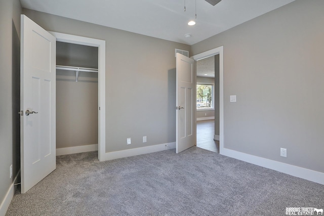 unfurnished bedroom featuring carpet flooring and a closet