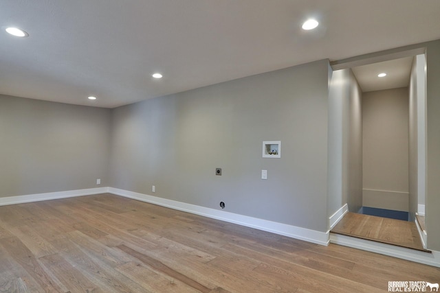 clothes washing area featuring hookup for a washing machine, hookup for an electric dryer, and light hardwood / wood-style floors