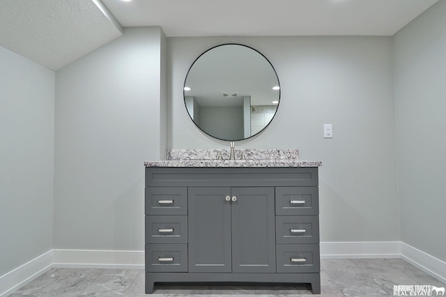 bathroom featuring vanity and a textured ceiling