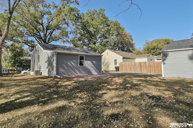 back of property featuring a yard, a patio area, and central air condition unit