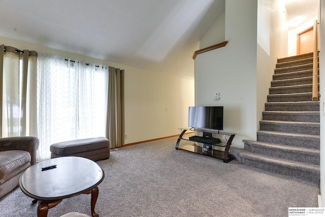 carpeted living room with lofted ceiling