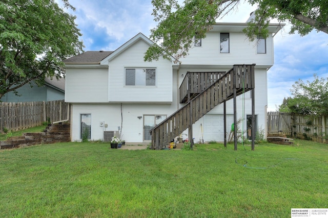 rear view of property with a wooden deck and a yard