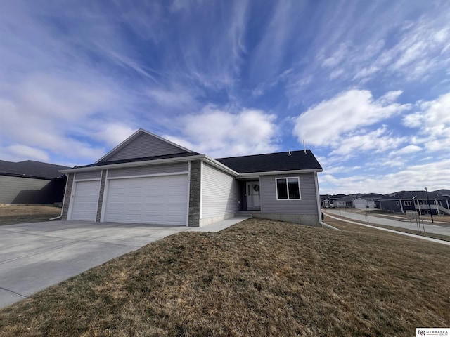 single story home featuring a garage and a front lawn