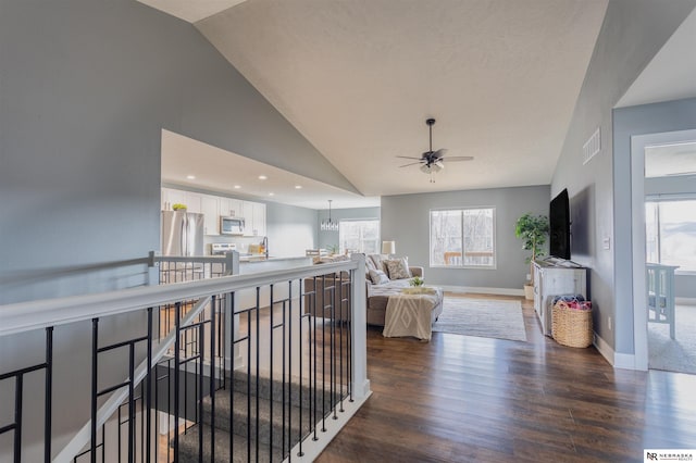 living room with lofted ceiling, dark hardwood / wood-style floors, and a healthy amount of sunlight