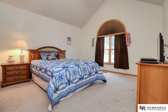 bedroom featuring lofted ceiling and carpet