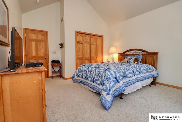 bedroom featuring high vaulted ceiling, light carpet, and a closet