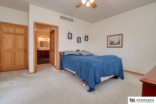 bedroom with carpet, ceiling fan, and ensuite bathroom