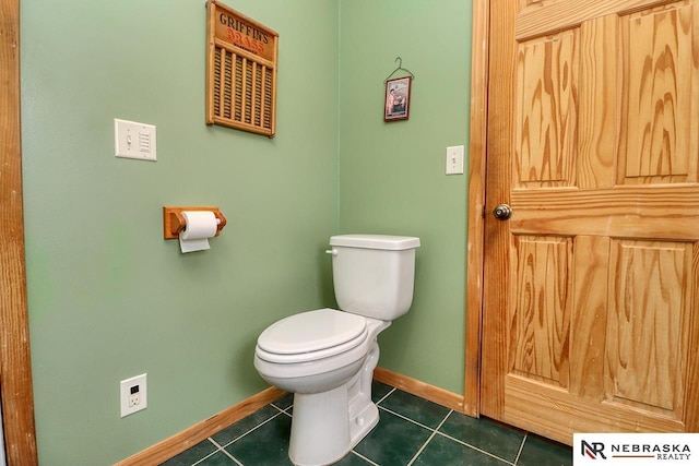 bathroom featuring toilet and tile patterned flooring