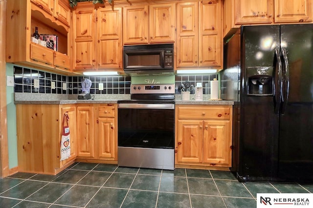 kitchen with dark tile patterned floors, decorative backsplash, and black appliances