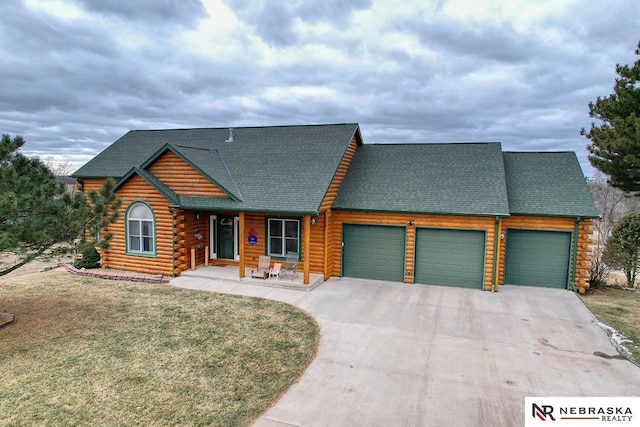 log cabin with a garage and a front yard