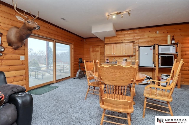 dining space featuring log walls