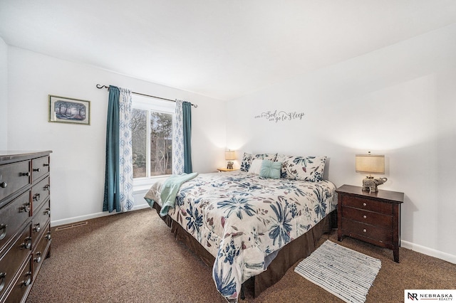 carpeted bedroom featuring baseboards