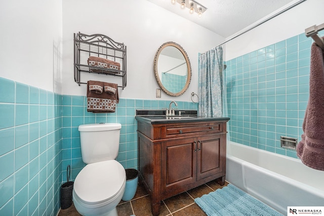 bathroom featuring tile patterned flooring, toilet, wainscoting, tile walls, and shower / bathtub combination with curtain