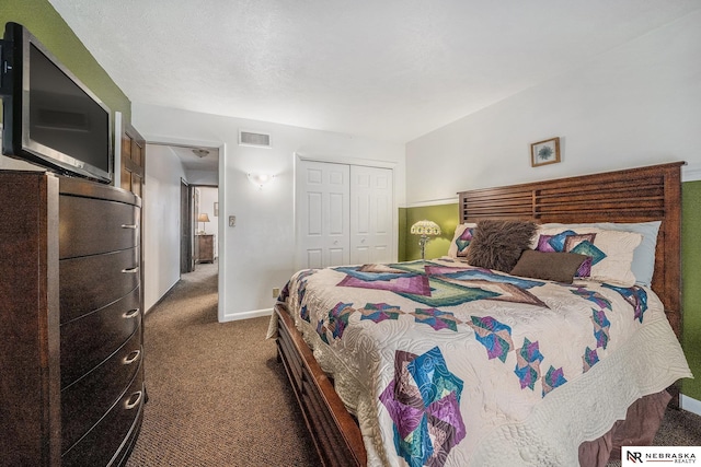 carpeted bedroom with visible vents, baseboards, and a closet