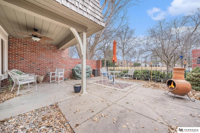 view of patio / terrace with area for grilling, a ceiling fan, and fence