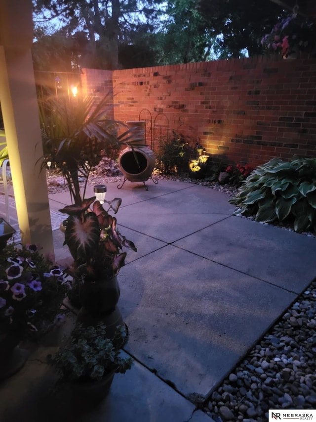 view of patio / terrace featuring an outdoor fire pit and fence