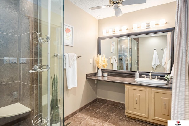 bathroom with walk in shower, tile patterned floors, vanity, and a textured ceiling