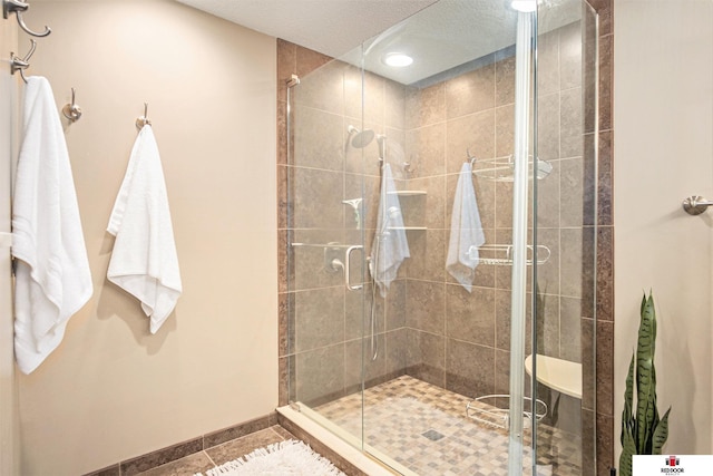 bathroom featuring tile patterned floors and a shower with door