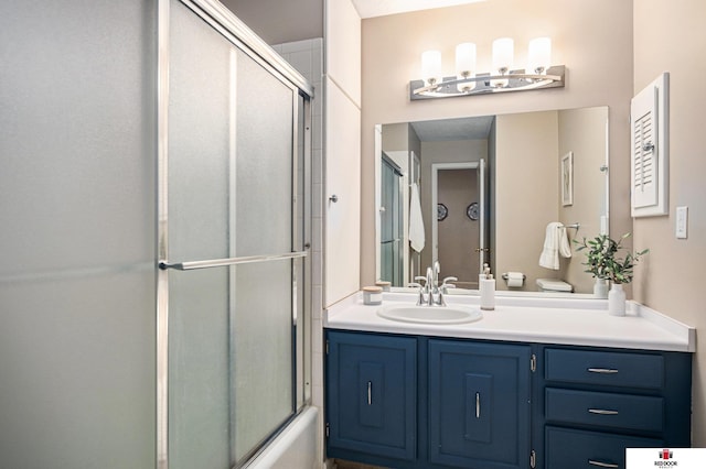 bathroom with vanity and shower / bath combination with glass door