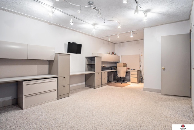 unfurnished office featuring built in desk and a textured ceiling