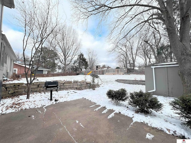 yard covered in snow featuring a playground