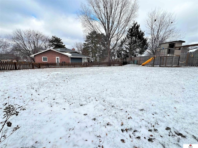 snowy yard with a playground