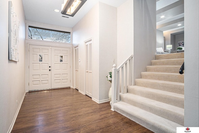 entryway featuring a high ceiling and dark hardwood / wood-style floors